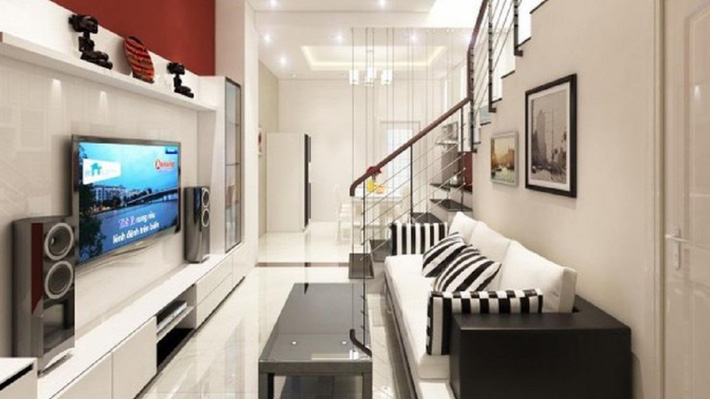 Ảnh chụp phòng khách trong ngôi nhà ống 4 tầng được thiết kế theo phong cách hiện đại, sang trọng với đồ nội thất được bố trí chạy dọc theo hai bên tường Tư vấn thiết kế nhà ống 4 tầng