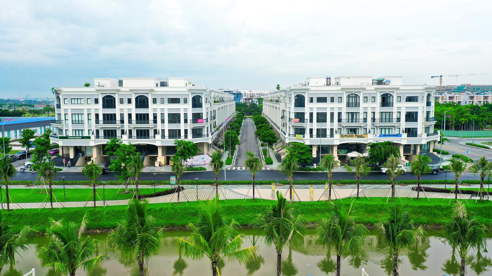 hai dãy nhà màu trắng, phía trước là đường và cây xanh
