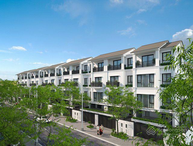 A row of white buildings with trees
Description automatically generated